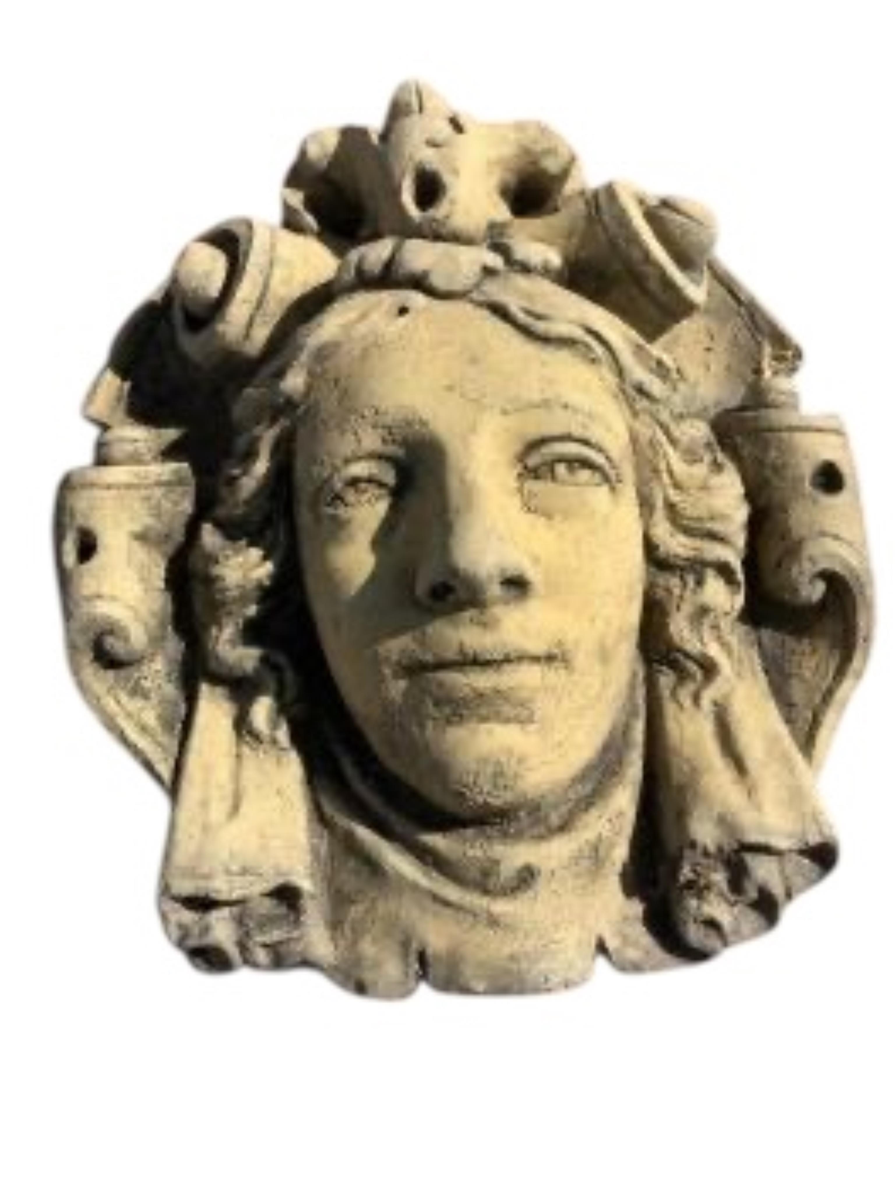 Three cast stone and terracotta garden wall mask appliqués, largest height 42cm